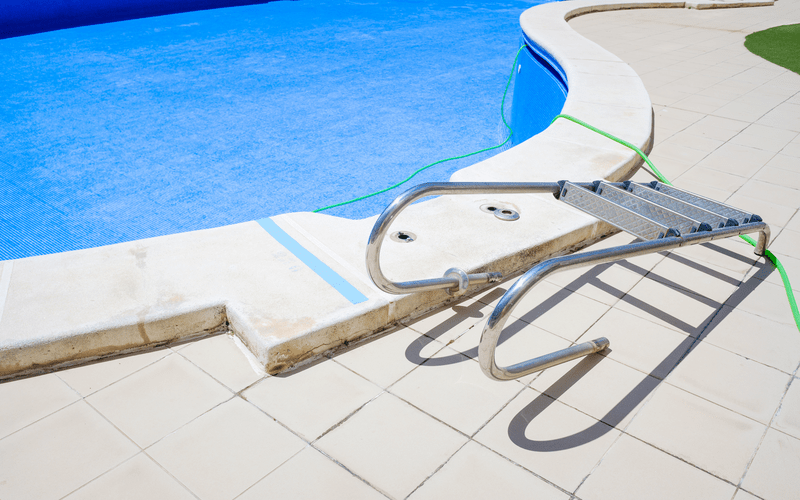 cleaning-an-empty-swimming-pool-in-a-residential-home